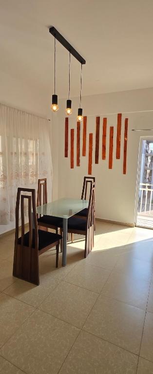 a dining room with a table and two chairs at Modern Secured Condo Apartments 1 in Tema