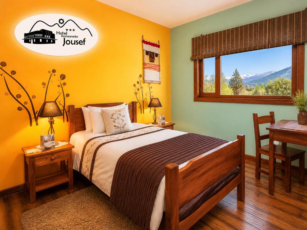a bedroom with a bed and a table and a window at Hotel Jousef in Puquio
