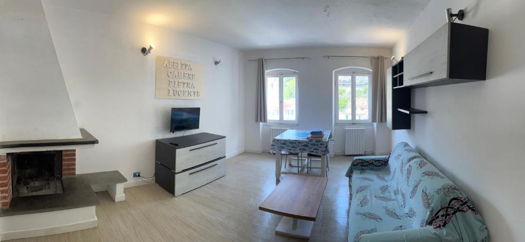 a living room with a couch and a fireplace at Affittacamere Pietra Lucente in Riomaggiore