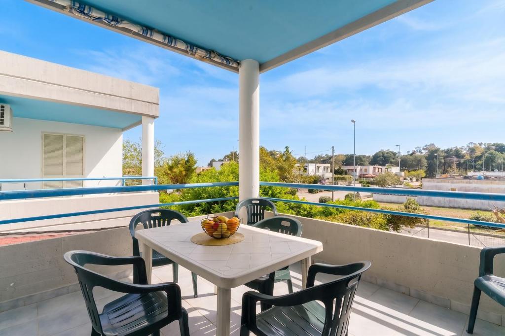 a table and chairs on a balcony with a view at Casa Celeste a Torre dell'Orso in Torre dell'Orso