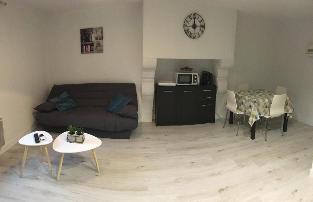 een woonkamer met een bank en een tafel bij Studio à Hennebont in Hennebont