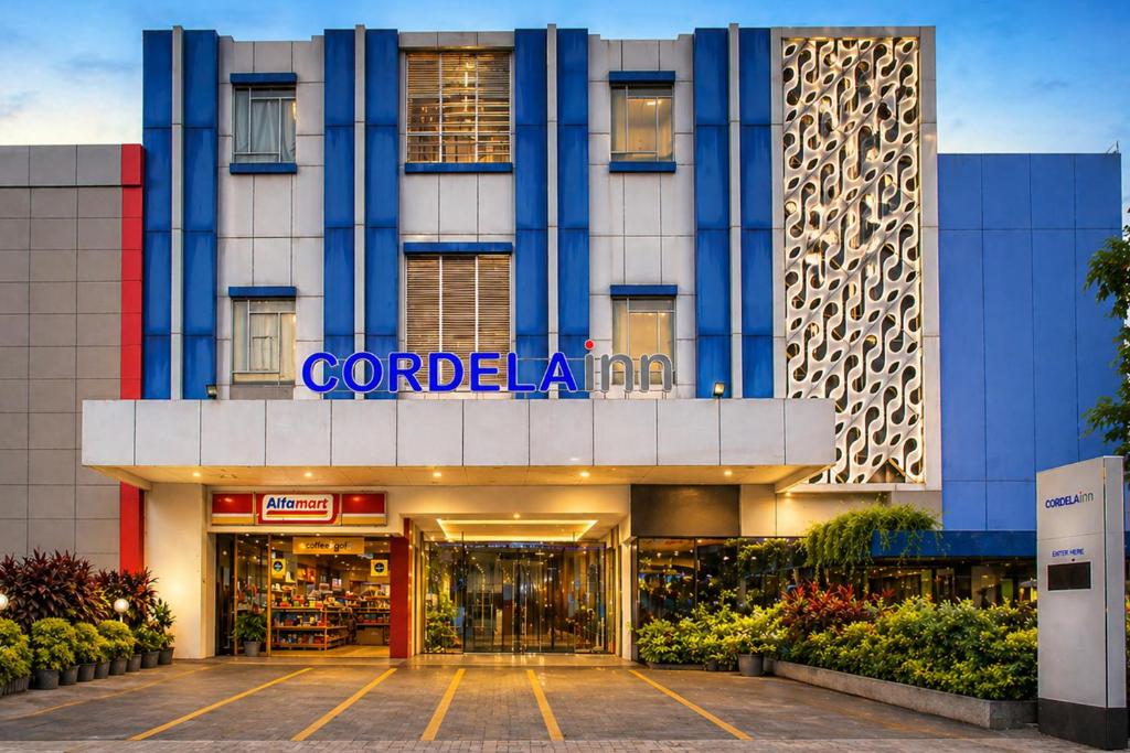 a store front of a building with a sign on it at Cordela Inn HM Yamin Medan in Medan