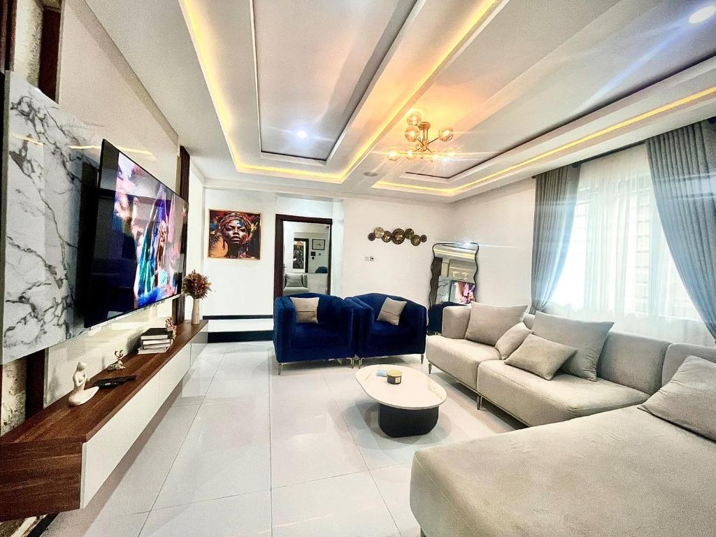 a living room with a couch and a tv at VeraVistaStays in Odo