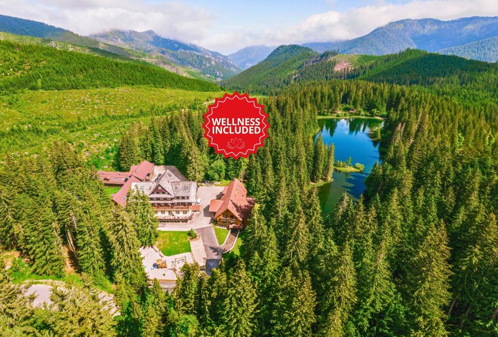 an aerial view of a resort with a lake and mountains at Hotel Mikulášska Chata in Belá