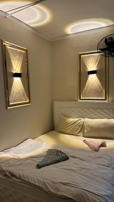 a bedroom with a bed with two mirrors above it at El Temsah Hotel in Cairo