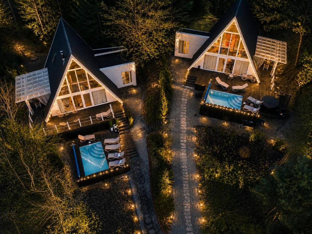 an aerial view of a home at night with lights at Fazenda Wood in Mlynki