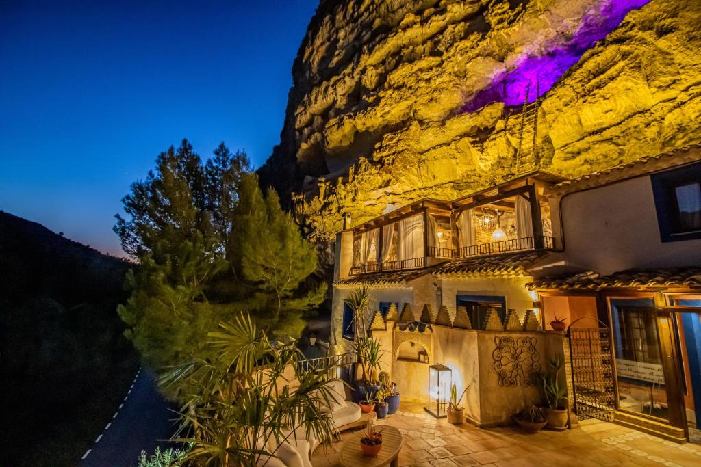 a house in front of a mountain at night at XUQ Hotels Alaxara in Cubas