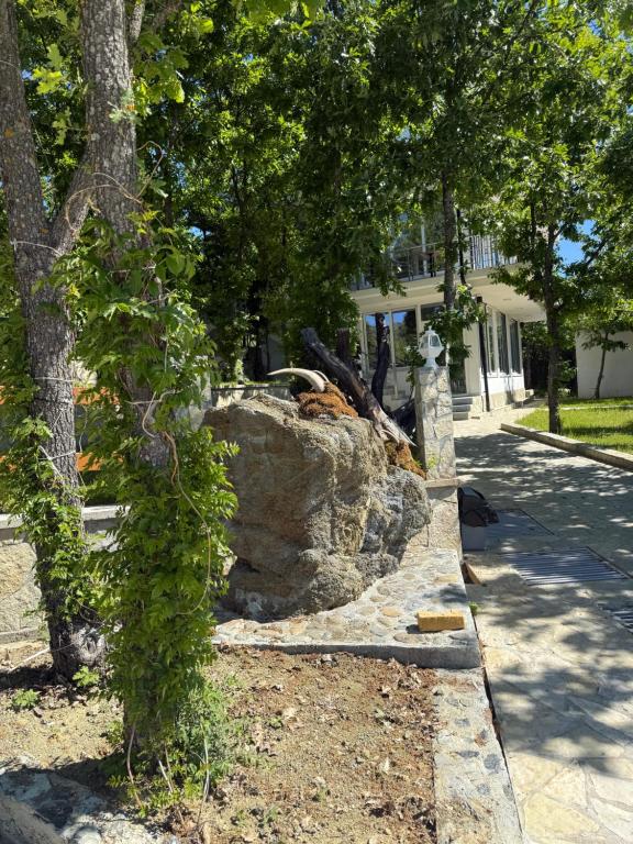 a stone wall in front of a house at Panorama Helshan Hotel in Helshan