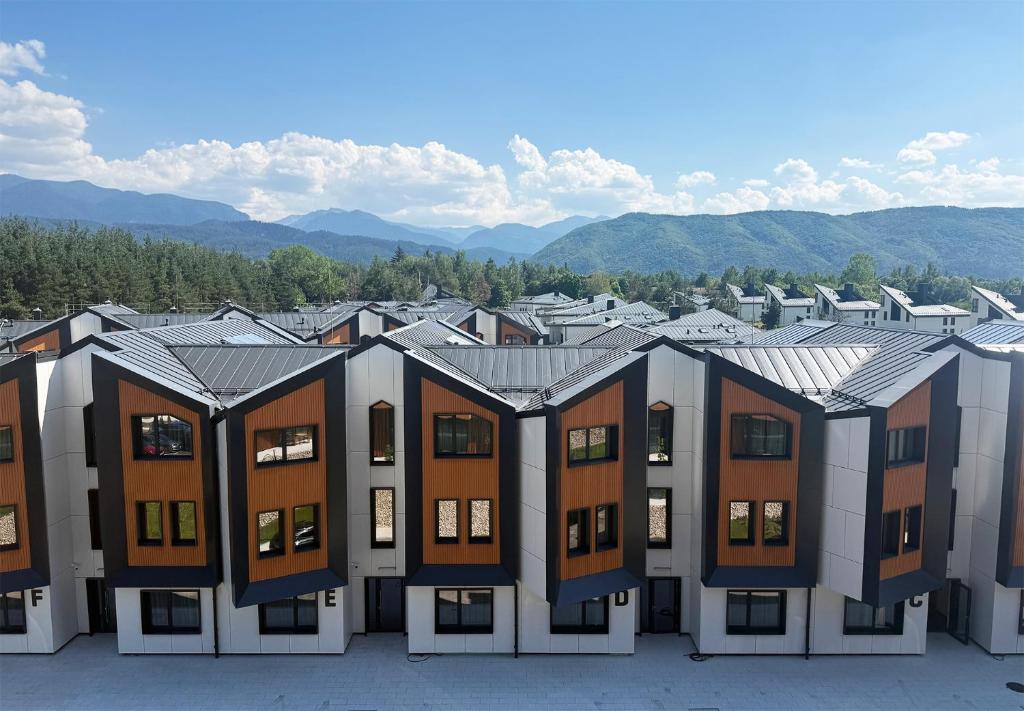 a row of houses in front of a city at Aparthotel SamElyon in Samokov