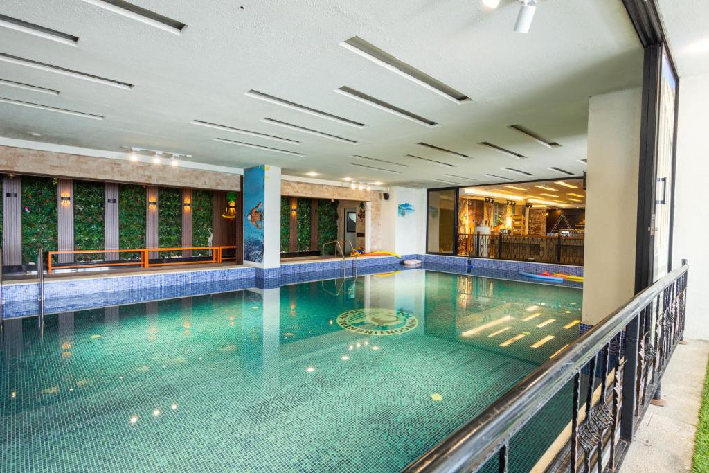 a swimming pool in a building at Dolphin Continental Hotel in Kuwait