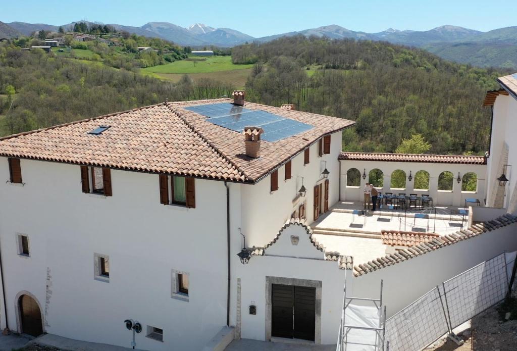an aerial view of a white building with a swimming pool at Claustrum di Colforcella in Cascia