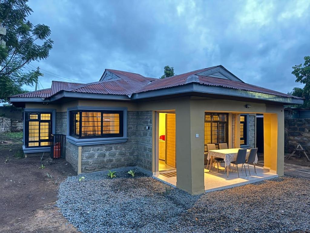 a small house with a table in front of it at Gono Retreat Four bedroom in Kisumu