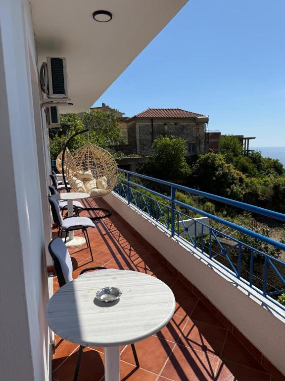 a balcony with tables and chairs on a balcony at Guesthouse Mili in Piqeras