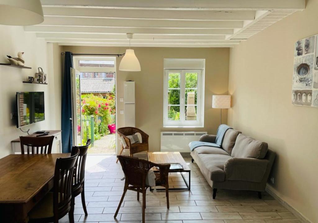 a living room with a couch and a table at Maison de pêcheur in Étretat