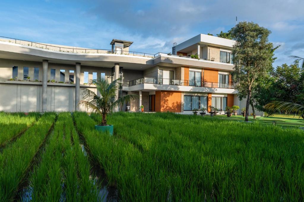 an image of a house with a green lawn at Villa 234 Yogyakarta in Yogyakarta