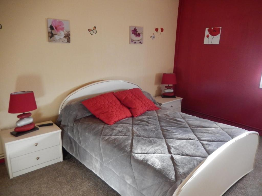 a bedroom with a bed with two night stands and two lamps at Chez Corinne in La Roche-Chalais