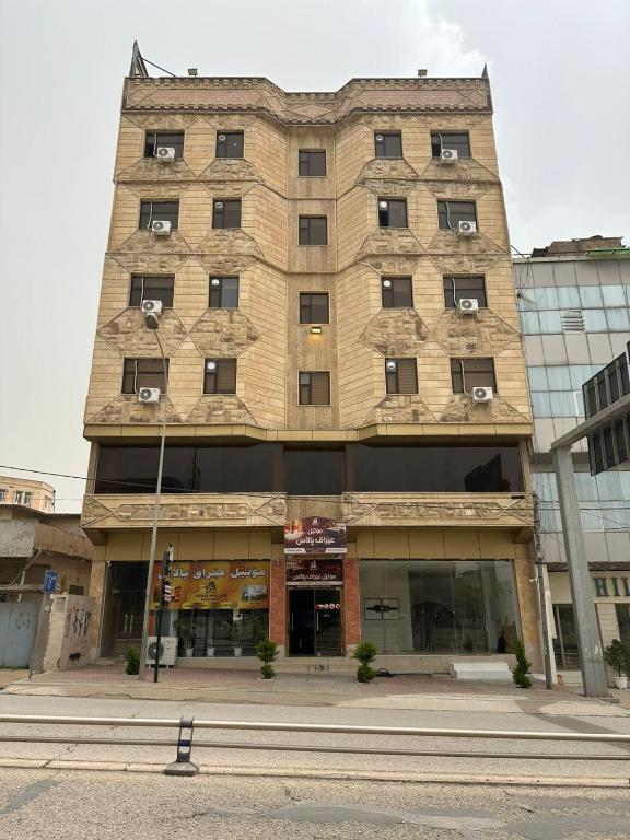 a tall building with windows on the side of it at Iraq palace apartment in As Sulaymānīyah