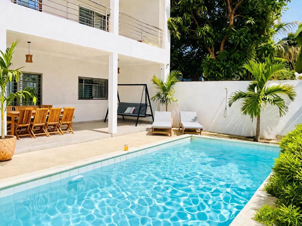 a swimming pool in the backyard of a house at Villa Keur Lune - Saly - SENEGAL in Saly Portudal