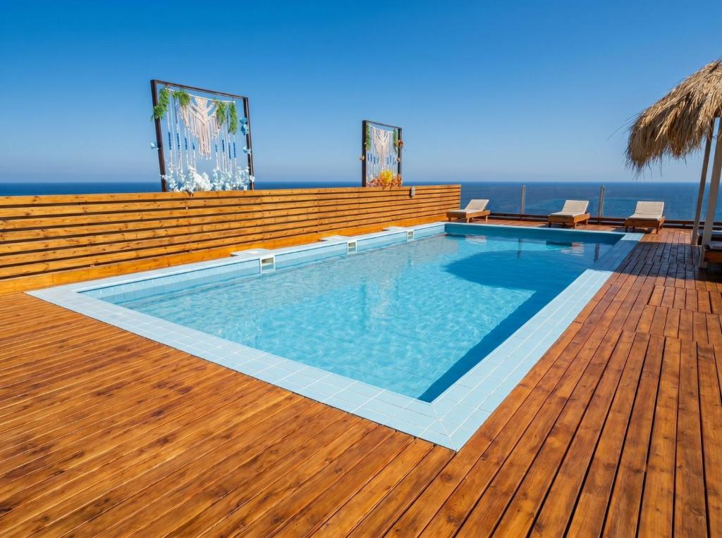 a swimming pool on a deck with the ocean in the background at Soly Apartments in Hurghada