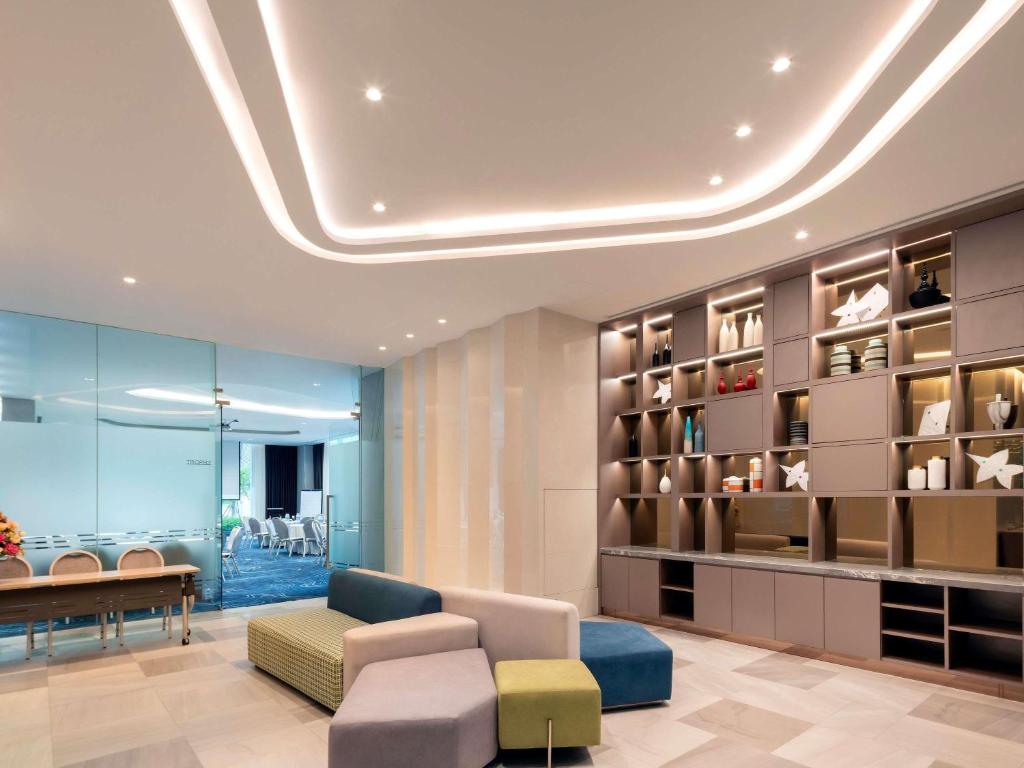 A colorful hotel seating area beside a decorative display wall.