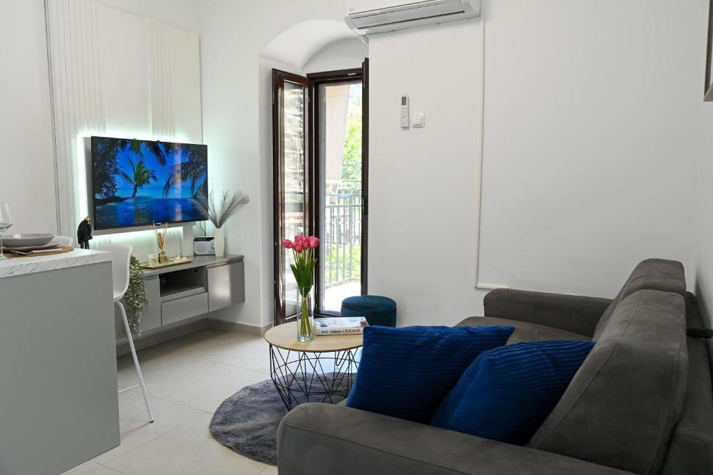 a living room with a couch and a tv at Studio Mare Kotor in Dobrota