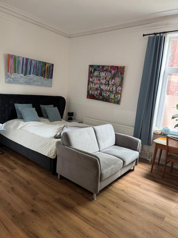 a bedroom with a bed and a couch at Elfenvilla in Erkelenz