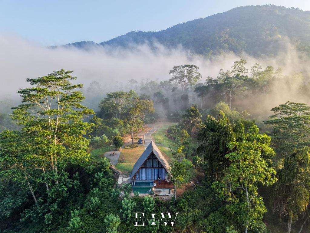 a house in the middle of a forest in the mist at 8 Acres Tea Escape in Deniyaya