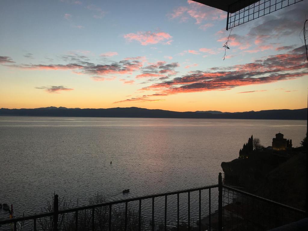 a sunset over a body of water at Apartment Kaneo in Ohrid