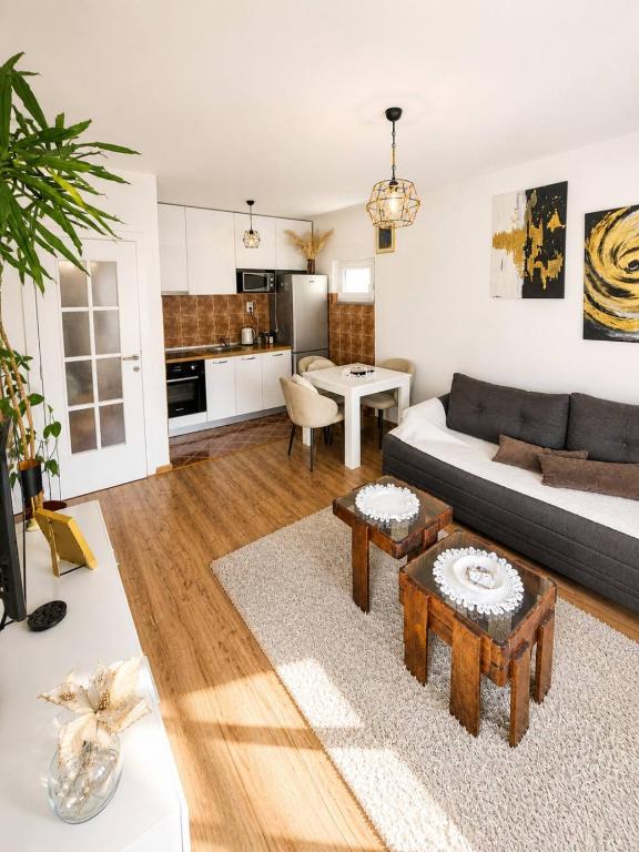 a living room with a couch and a table at Apartman MATEJ in Vranješ