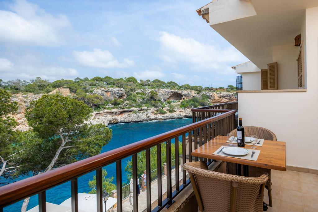 a balcony with a table and a view of the water at Cala Figuera Apartment 3b in Cala Figuera