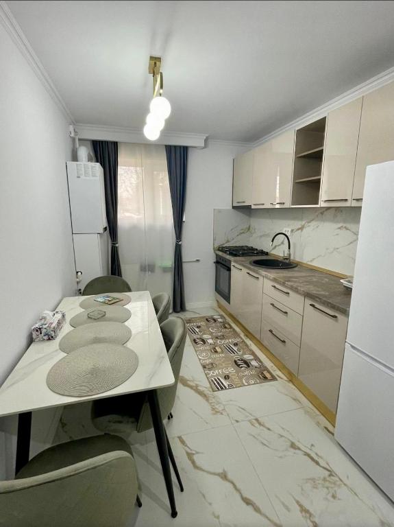 a kitchen with a table and chairs in a room at Luxbab in Drobeta-Turnu Severin