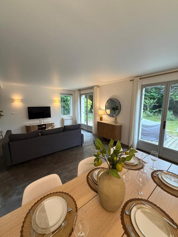 a living room with a table and a couch at Casa Limon, Charm & Serenity in Cesson-Sévigné
