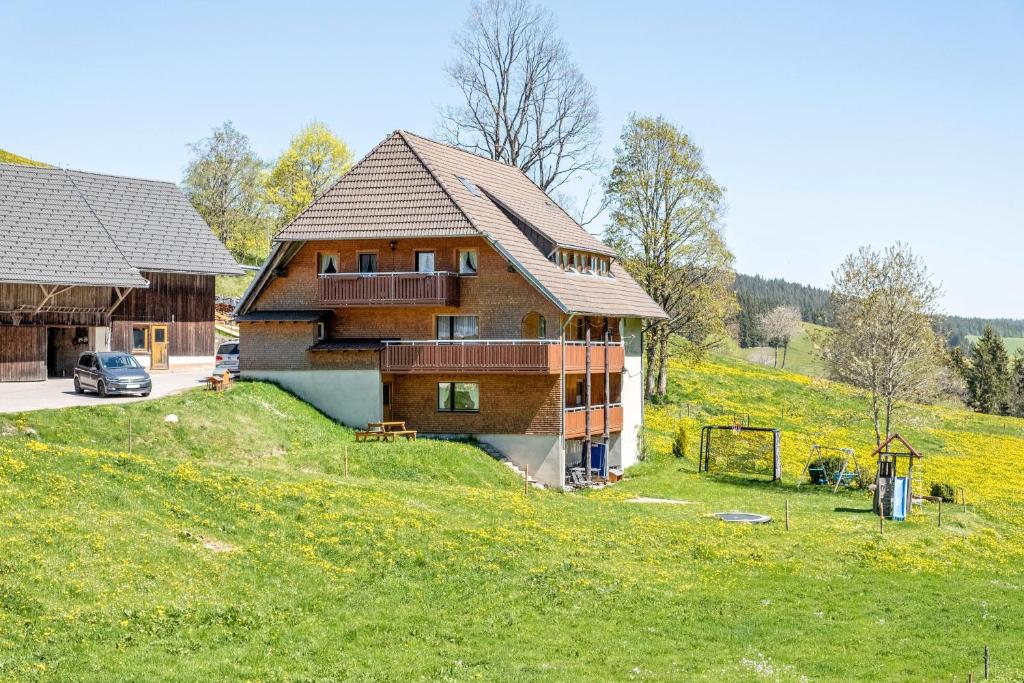 a house on top of a grassy hill at Altvogtshof in Furtwangen