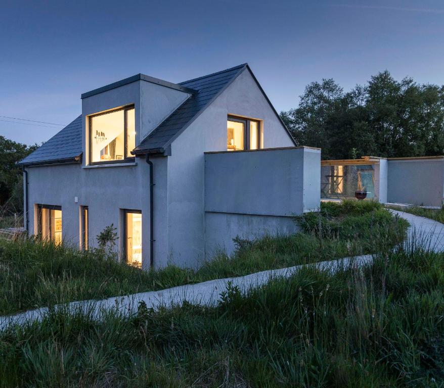 a house that is sitting in the grass at Pheasants Call in Kenmare