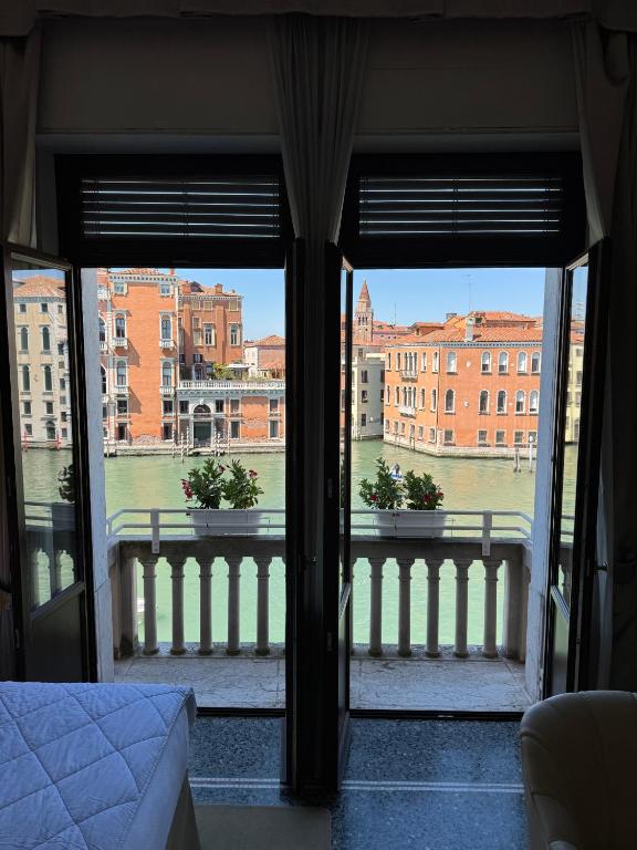 a view of a city from a bedroom window at Palazzo Barocci in Venice