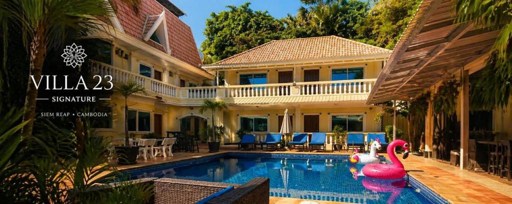 a swimming pool in front of a house at La Villa 23 Signature in Siem Reap