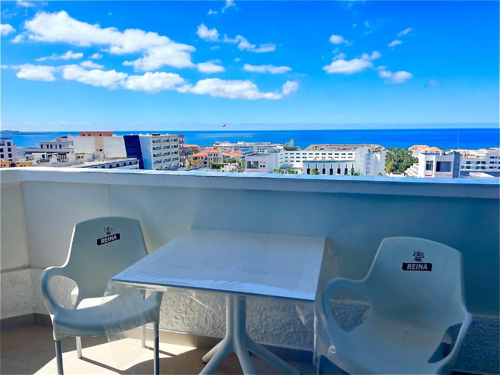 a table and chairs on a balcony with a view of the ocean at playa honda sky view in Playa de las Americas