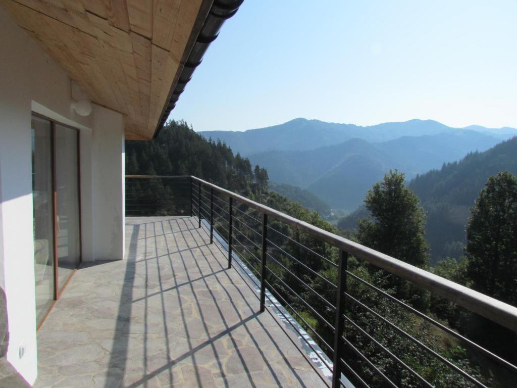a balcony of a house with a view of mountains at Sabri's Penthouse in Ogled