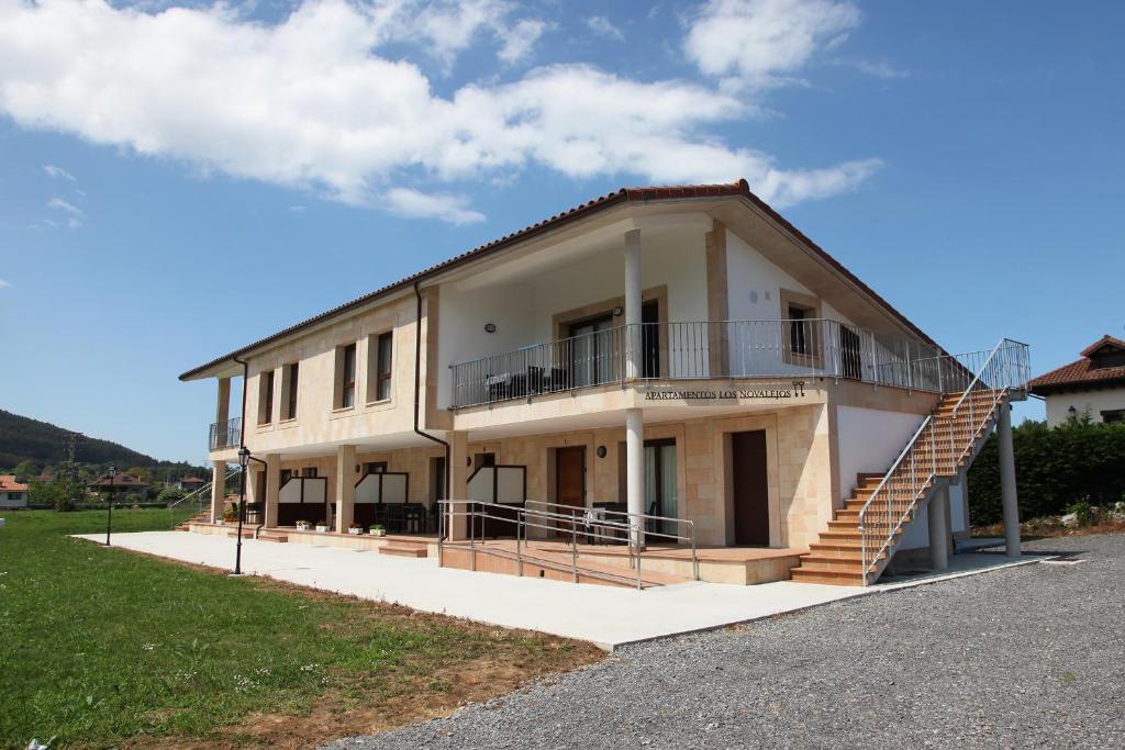 a building with a staircase on the side of it at Apartamentos Los Novalejos in Arnuero