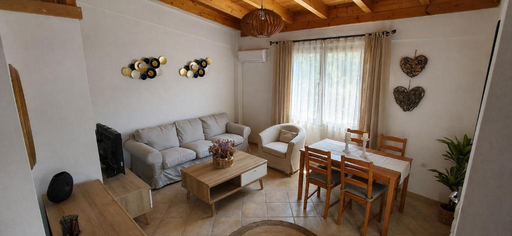 a living room with a couch and a table at Sea & Sun Ikaria in Gialiskari