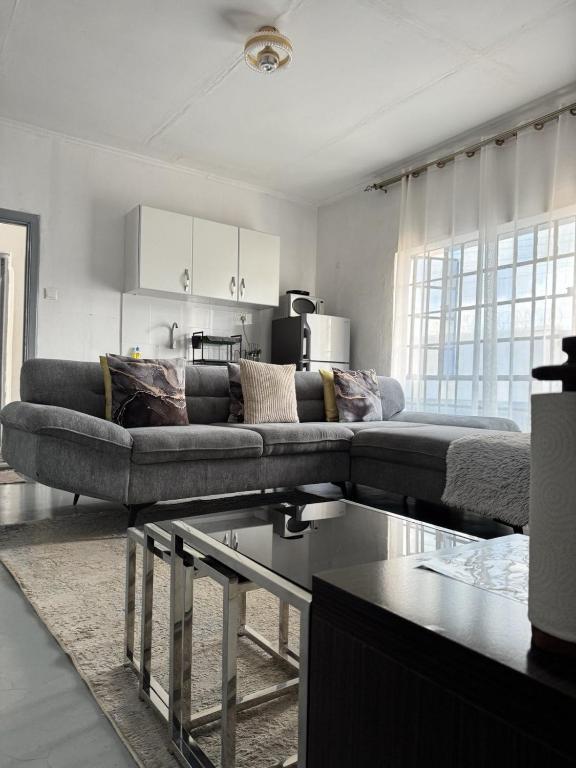 a living room with a couch and a table at Platinum House in Nyeri