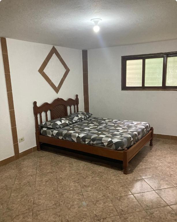 a bedroom with a bed in the corner of a room at Makana Surf Camp in Ubatuba