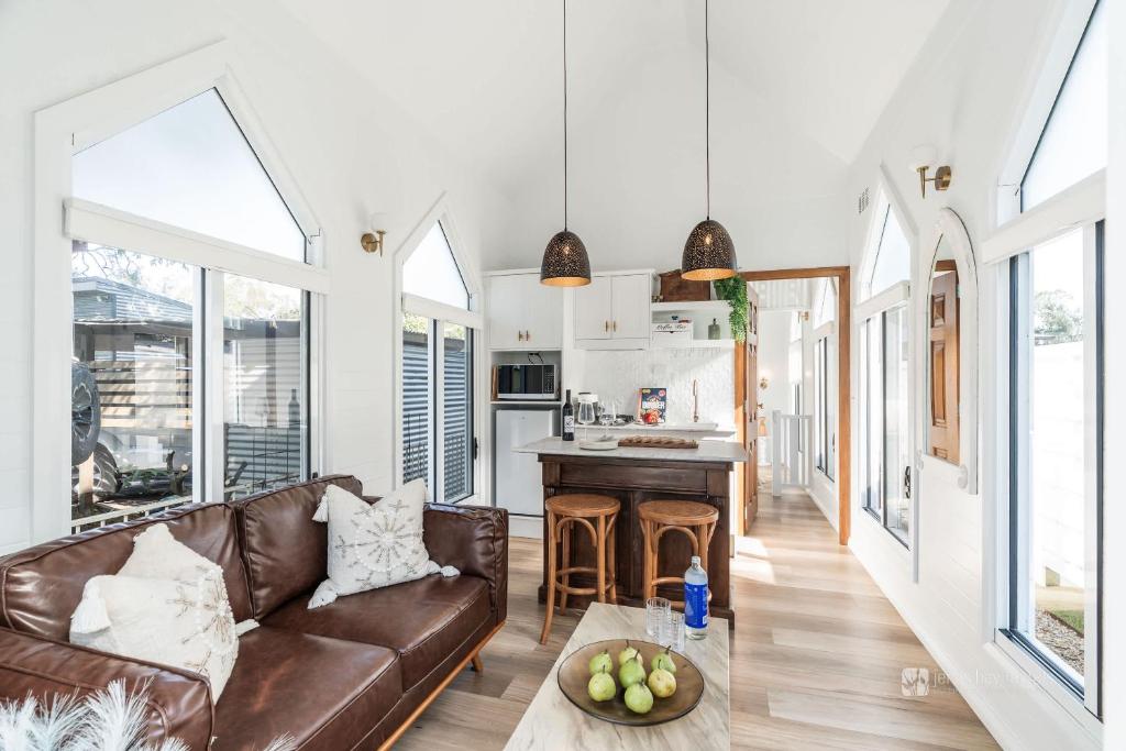 a living room with a couch and a table at Chapel by the Bay in Erowal Bay