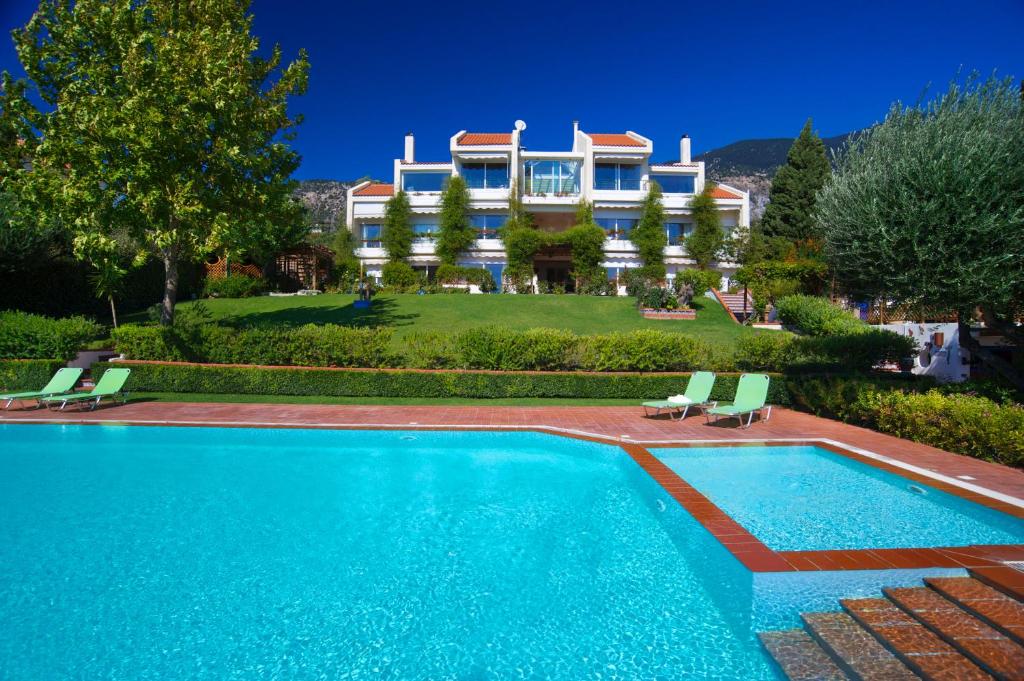 a large house with a swimming pool in front of it at Felix Residence & Lucia Simona Villas in Mousata