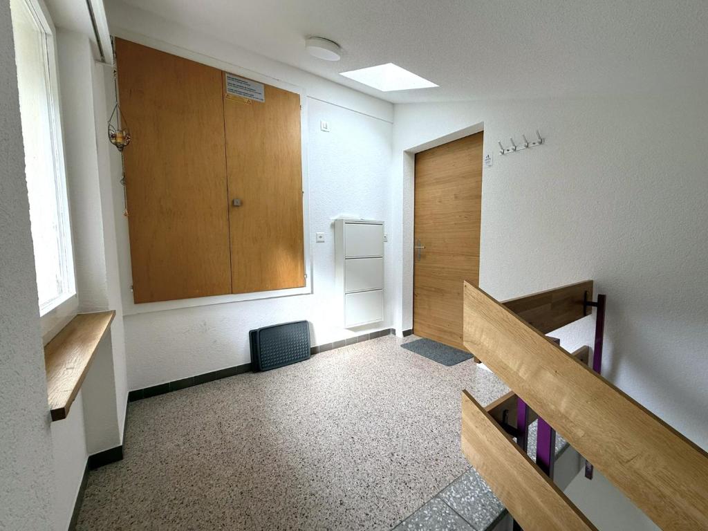 an empty hallway with benches and a door in a room at Diana 9 in Leukerbad