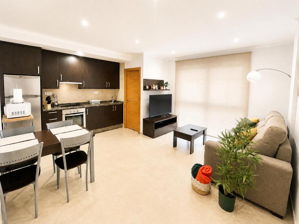 a kitchen and living room with a couch and a table at RELAX VIVEIRO in Viveiro