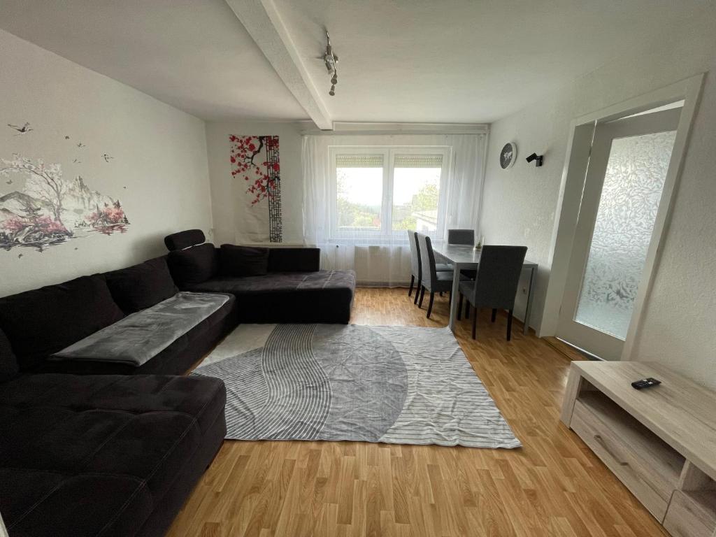 a living room with a couch and a table at Ferienhaus Weitblick in Masserberg