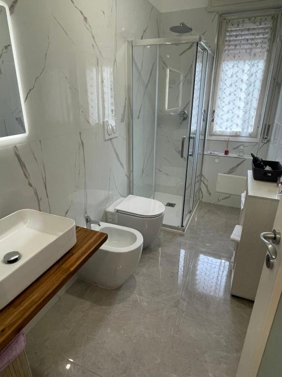 a bathroom with a toilet and a sink and a shower at Casa Alessia Sanremo in Sanremo