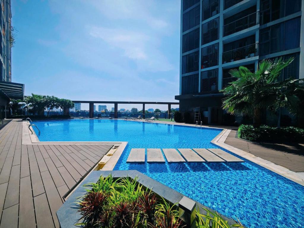 a large blue swimming pool in a building at Eco Green Apartment Residence District 7 in Ho Chi Minh City