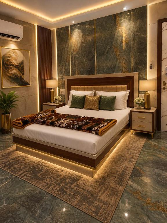a bedroom with a large bed in a room at Pamma hotel in Anandpur Sāhib